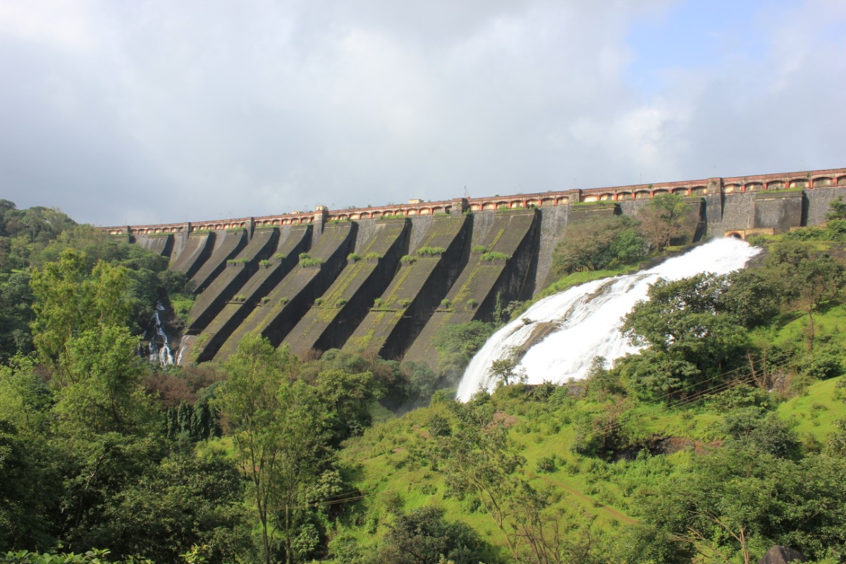 Wilson Dam Bhandardara overflowing from spillway during peak monsoon August 2026